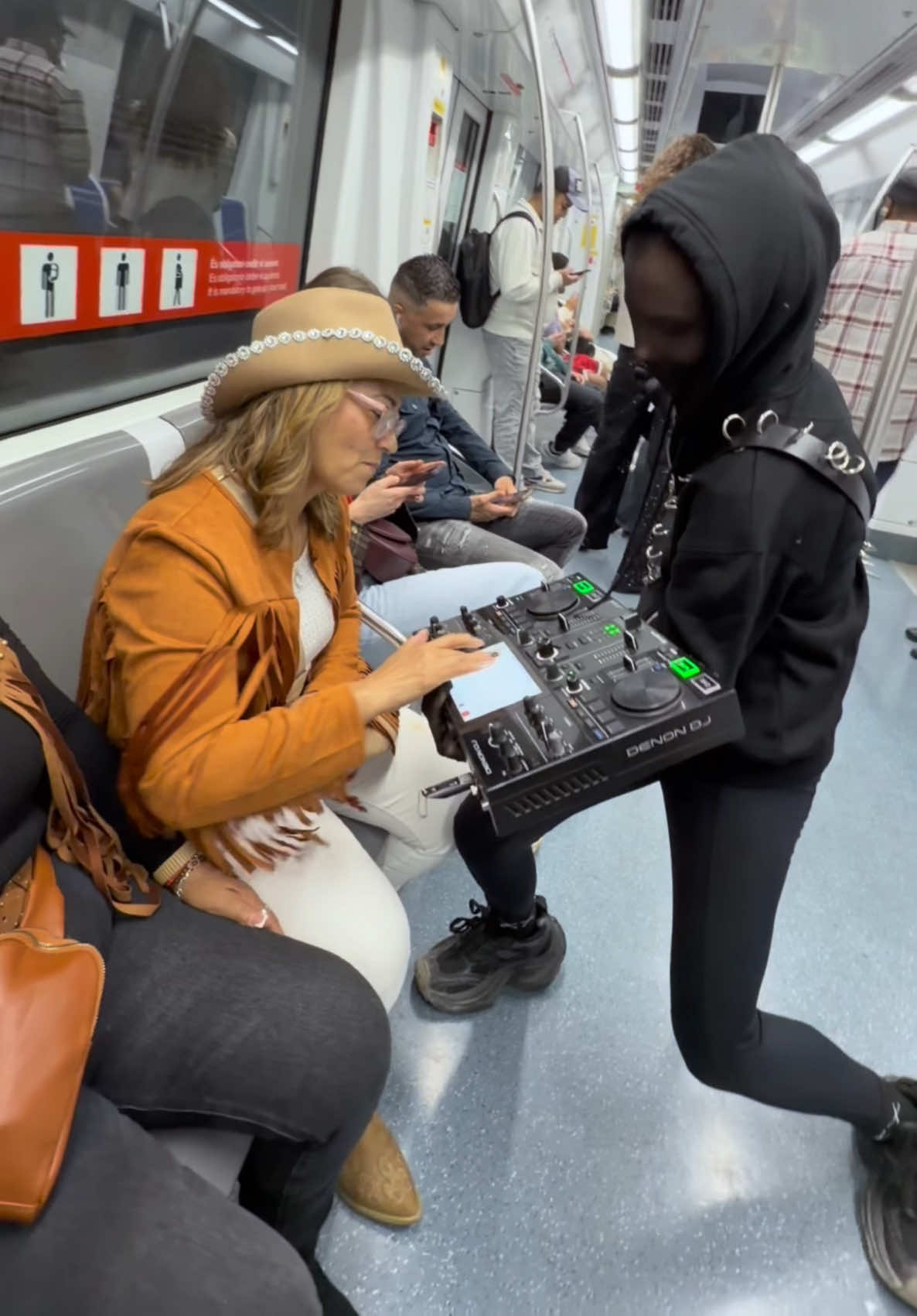 Strangers trying DJing in the metro